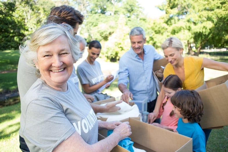 Happy volunteer family separating donations stuffs on a sunny day.jpeg